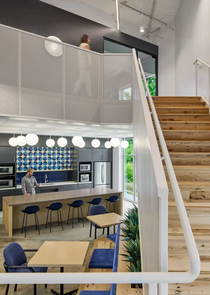 Modern office space with staircase and kitchen