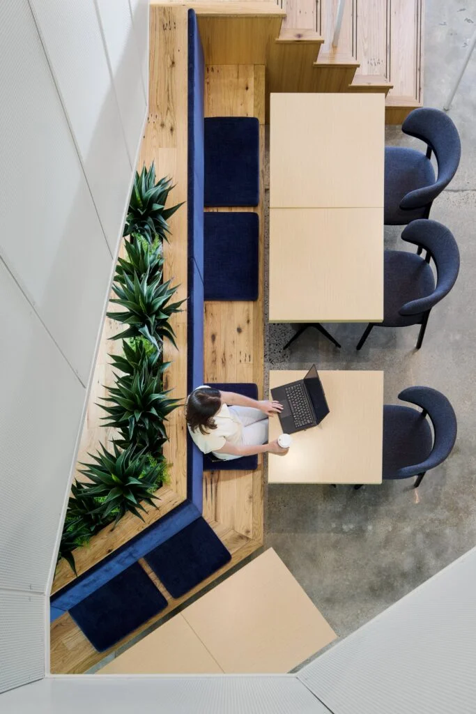 Modern workspace with plants and seating.