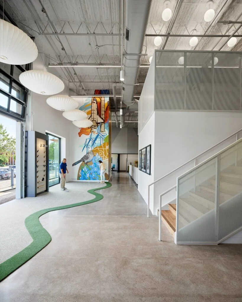 Modern office with colorful mural and stairs