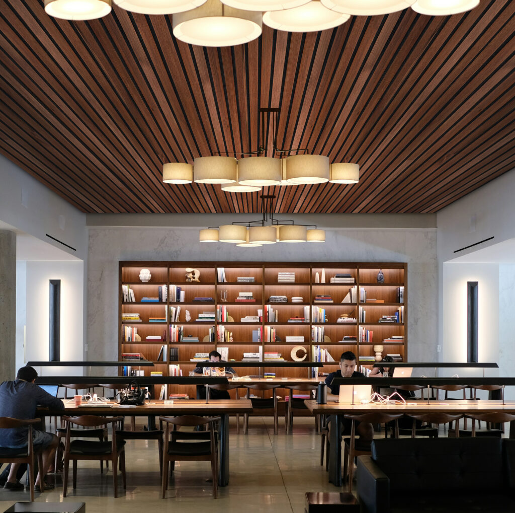 ACP3 1 Modern library with wooden acoustic ceiling panels decor.