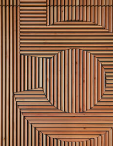 Custom sustainable wood millwork, expertly crafted for unique design applications. Slat panels made of solid wood, used to create a logo or custom design.